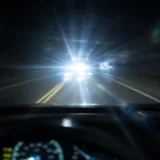 夜間運転中に対向車のヘッドライトが乱視により放射状ににじんで見えるイメージ